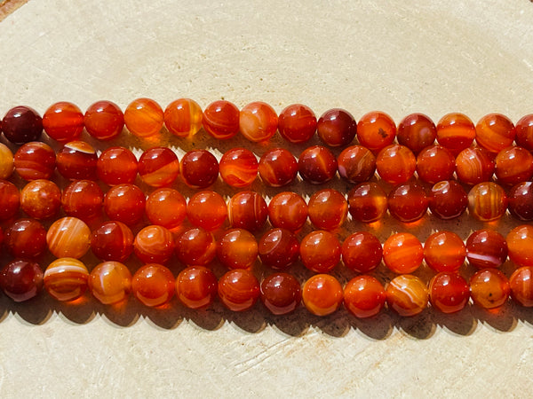Perles en pierre naturelle en Agate rouge à bandes en 8 mm - les bijoux de Thea 