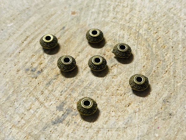 Lot de 20 intercalaires Rond Tibet bronze pour bracelet - les bijoux de Thea 