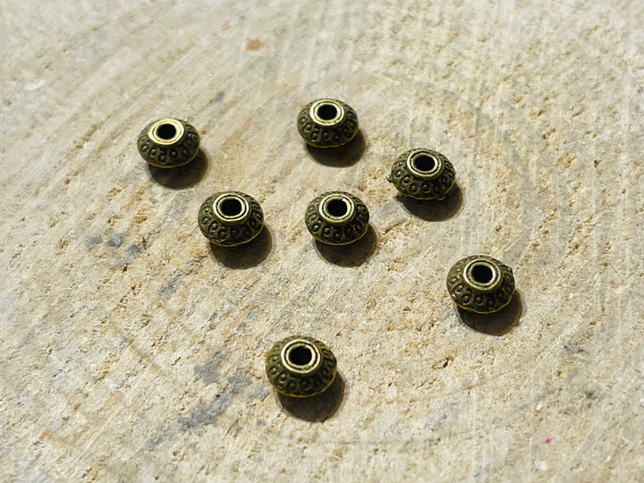 Lot de 20 intercalaires Rond Tibet bronze pour bracelet - les bijoux de Thea 