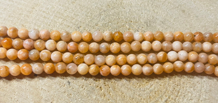 Perles naturelles en Calcite orange pêche en 6 mm - les bijoux de Thea 