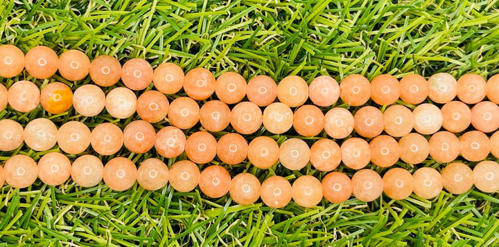 Perles naturelles en Calcite orange pêche en 8 mm - Les bijoux de Théa